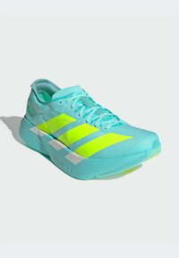 Lightweight running shoe in turquoise mesh, featuring bright yellow accents and three stripes, with a textured surface and a sleek, aerodynamic design.