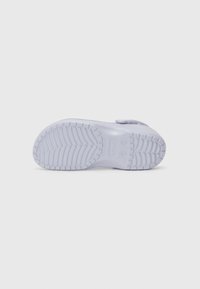 Light purple rubber shoe with textured sole. Features a back strap and smooth upper surface, designed for comfort and stability.