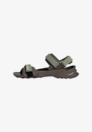 Olive green sandals with Velcro straps, a textured sole, and molded footbed. Features a sporty design and angled heel for stability.