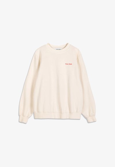 Sweat crème manches longues col rond avec texte rouge ""Tea Club"" sur la poitrine gauche et poignets et bas côtelés.