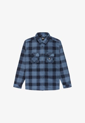 Blue and black plaid flannel shirt with long sleeves, button-up front, two chest pockets, and a logo on the left side above the pockets.
