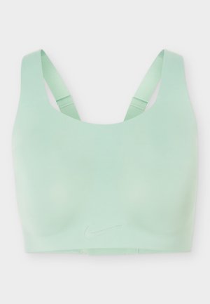 Ανοιχτό πράσινο αθλητικό σουτιέν χωρίς ραφές με ρυθμιζόμενους ιμάντες και το λογότυπο της Nike στο κέντρο μπροστά.