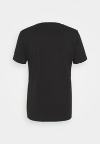 Black cotton t-shirt, short sleeves, crew neck, smooth texture, features a small accent on the left sleeve. Plain design, no patterns.