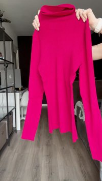 Fuchsia ribbed turtleneck sweater with long sleeves, featuring a fitted silhouette and soft texture. No visible hardware or patterns.