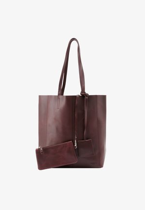 Burgundia nahast kott kahe käepidamee ja sileda tekstuuriga, minimalistlik disain, sisaldab väikest eemaldatavat kotti ja dekoratiivseid aksessuaare.