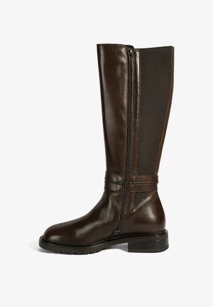 Braune Lederstiefel bis zum Knie mit glatter Oberfläche, seitlichem Reißverschluss, elastischem Einsatz und niedrigem Blockabsatz. Strukturierte Akzente am oberen Schaft.