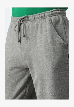 Graue Sweatpants aus weichem Stoff, mit einem elastischen Taillenbund und einem Zugband, seitlichen Taschen und einer glatten Textur.