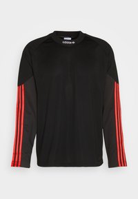 Black long-sleeve Adidas sports shirt with red three stripes running down both sleeves and a crew neck collar.