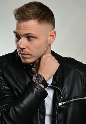 Stylish black leather jacket with quilted texture, white t-shirt, and a black watch featuring a round face, red accents, and a rubber strap.