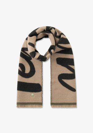 Beige wollen sjaal met zwart abstract patroon, afgewerkt met rafelige randen en een klein groen logotje vlak bij de onderrand.