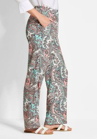 Pantalons à larges jambes avec un motif paisley coloré, en tissu léger, dotés d'une taille élastique et de poches latérales.