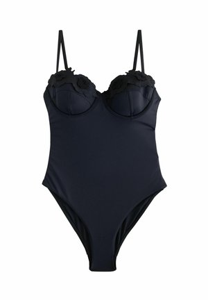Costume da bagno nero con spalline sottili regolabili, coppe imbottite e dettagli in pizzo floreale sul collo. Materiale liscio e elasticizzato, gambe alte.