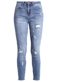 Vaaleansiniset skinny-farkut, jotka on valmistettu denim-kankaasta. Niissä on kulutettuja läiskiä ja purjehduksia, sekä klassinen viiden taskun muotoilu.