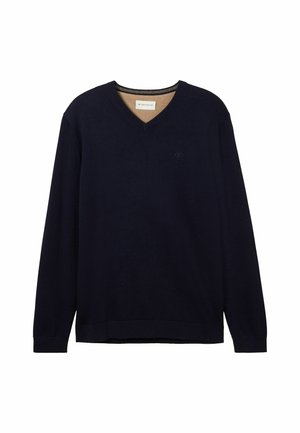 Pulover bleumarin cu decolteu în V, realizat dintr-un material moale, cu mâneci lungi, mansete cu nervuri și un logo subtil pe piept.