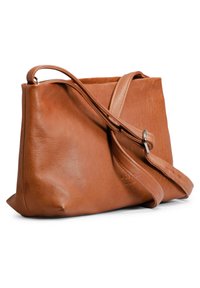 Brun läder crossbody-väska med mjuk textur, rundad form, enkel justerbar rem och subtilt präglad logotypdetalj.
