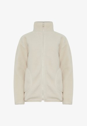 Chaqueta de forro polar beige con cuello alto, cremallera completa y dos bolsillos laterales. Textura suave y diseño casual, ideal para llevar en capas.