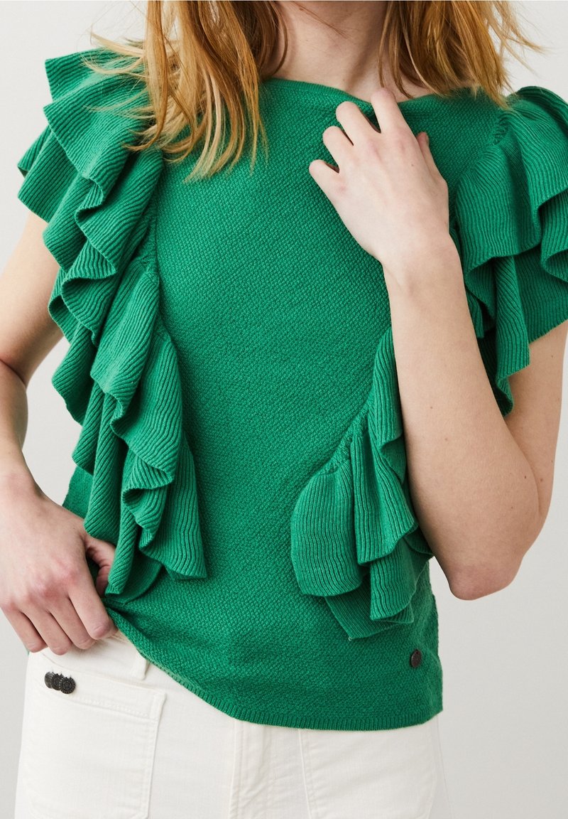 Pull en tricot vert avec des manches à volants, tissu texturé, coupe droite et un petit accent de logo sur l'ourlet.