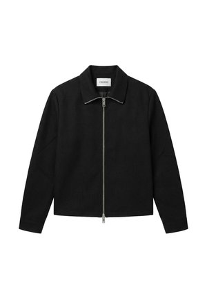 Svart jakke med lange ermer, sølvfarget glidelås foran og krage, merket "CISZERE", vist på hvit bakgrunn.