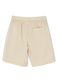 Tan shorts made of lightweight fabric, featuring an elastic waistband and a single back pocket with a flap. Smooth texture, tailored fit.