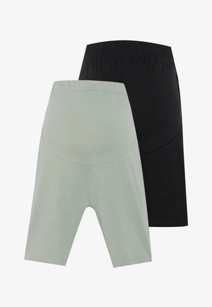 To par med midjelange shorts: en i lys grønn og den andre i svart, begge laget av mykt stoff med elastisk midjebånd.