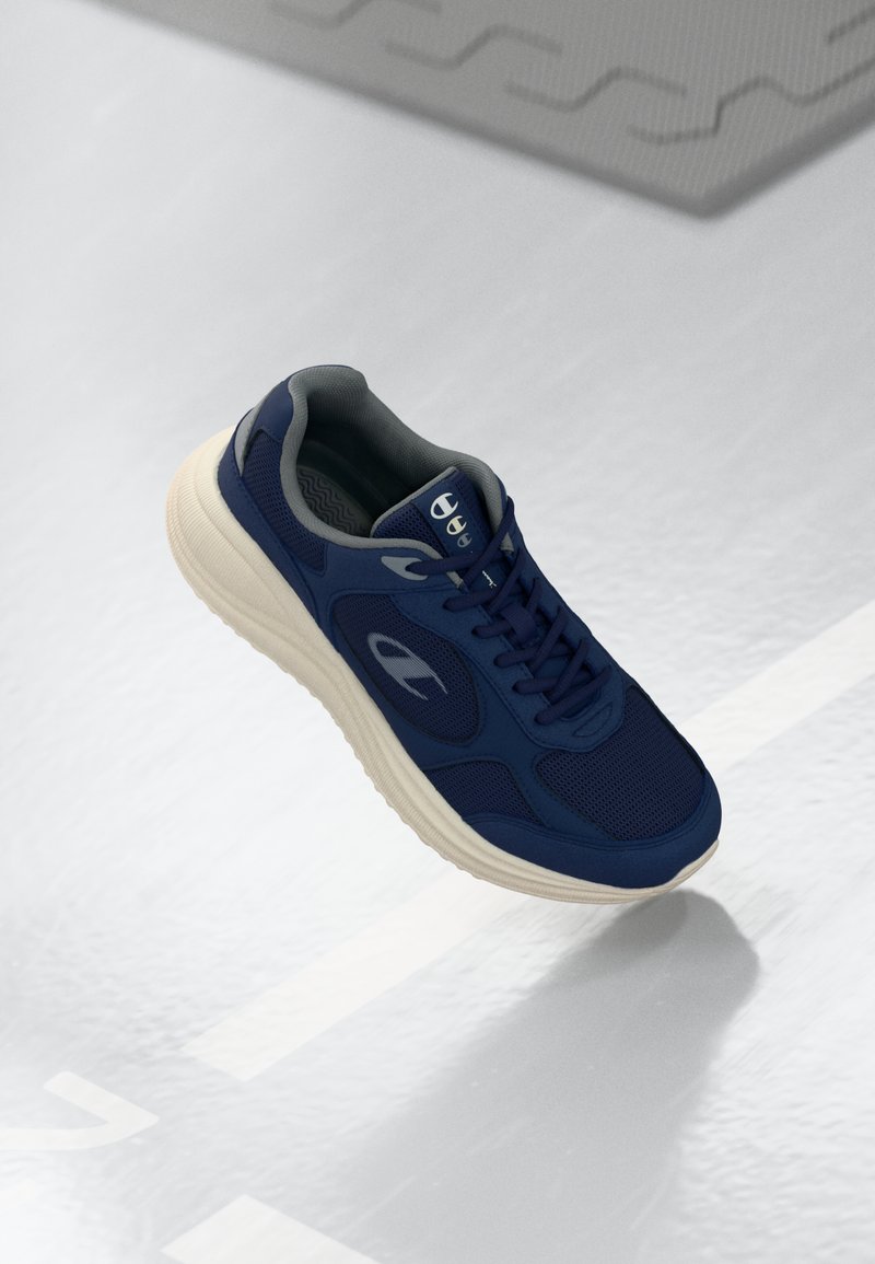 Navy running shoe with a breathable mesh upper, cushioned sole, and textured gray accents. Features lacing system and logo on the side.