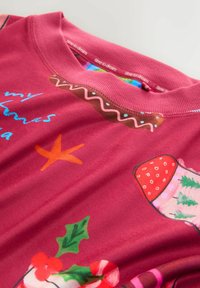 Red Christmas-themed shirt with holiday icons like a stocking, holly, starfish, and the phrase "time to dream" on the collar lining.