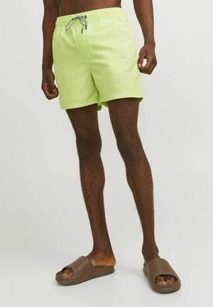 Limegrøn svømshorts med elastisk talje og snøre, med et hvidt logo print på siden og en afslappet pasform.