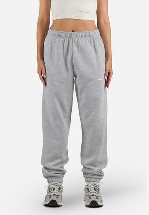 Gray sweatpants with an elastic waistband and cuffs. Features side pockets and a small logo on the left thigh. Soft cotton blend material.