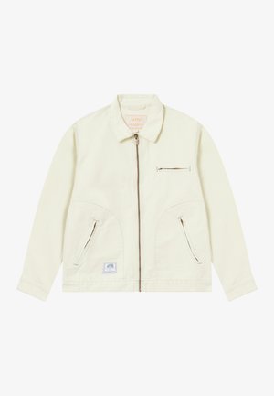 Light cream jacket with a front zip closure, pointed collar, two side pockets, and a chest pocket with thin zipper. Soft fabric texture.
