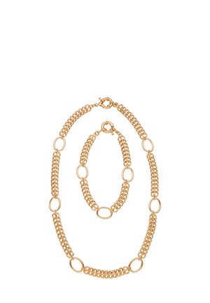 Guldtonet kædesmykke sæt med oval link-design, bestående af et halskæde og armbånd med skiftende glatte og teksturerede led.