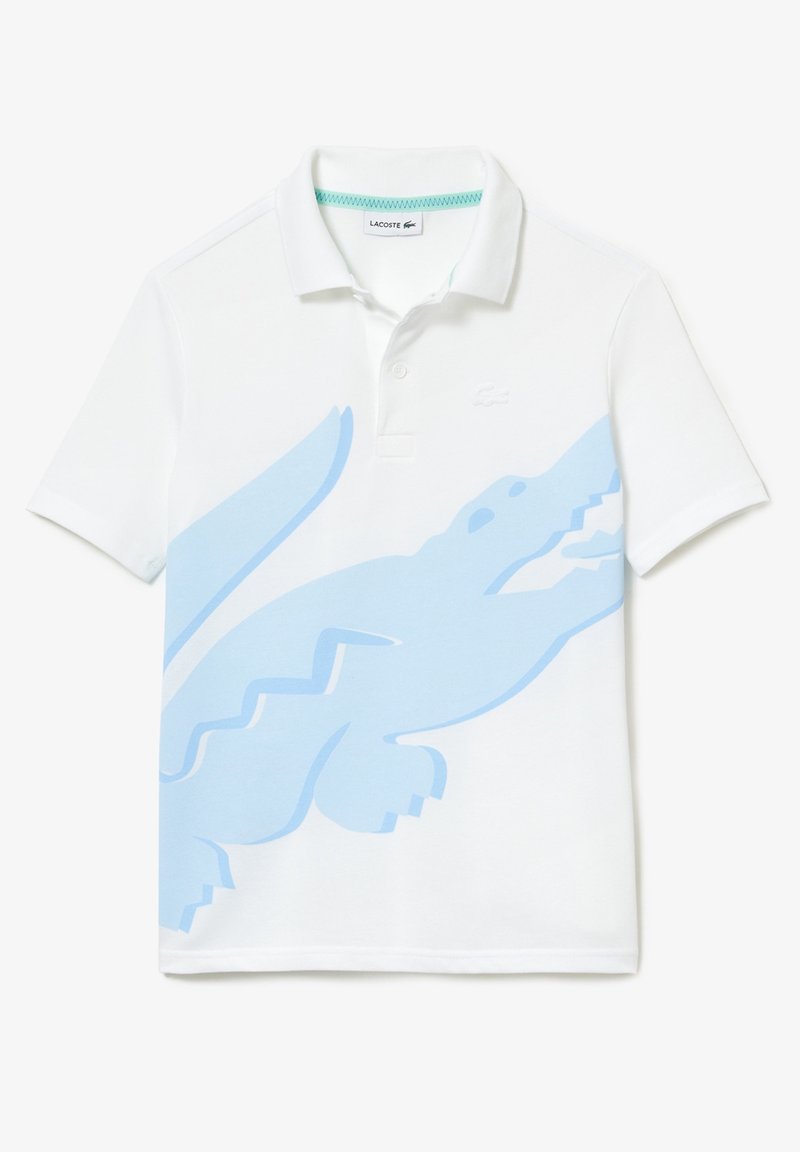 Polo blanc à manches courtes avec un grand motif crocodile bleu clair sur le devant et un petit logo crocodile brodé sur la poitrine.