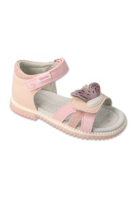 Różowe sandały z miękką skórzaną cholewką, zapięciem na rzep, dekoracyjnymi akcentami z brokatu i текстurowaną podeszwą. Zawierają ozdobę w kształcie serca.