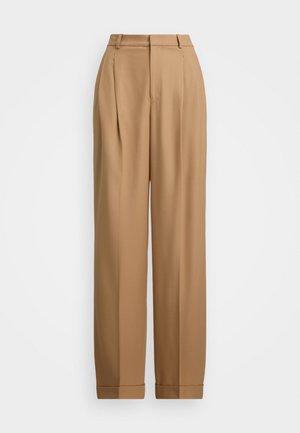 Beige farkut, joissa on korkea vyötärö, poimutettu etuosa, kapenevat lahkeet ja käännetyt hihnat. Sujuva kangas hienostuneella tekstuurilla.