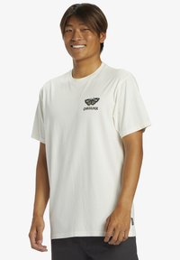 White cotton t-shirt featuring a butterfly graphic and "Quiksilver" text in black. Short sleeves and relaxed fit design.