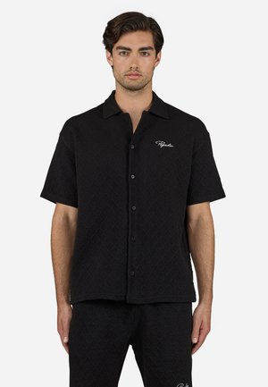 Black short-sleeve shirt with a textured diamond pattern, featuring a button-front closure and a logo embroidered on the left chest.