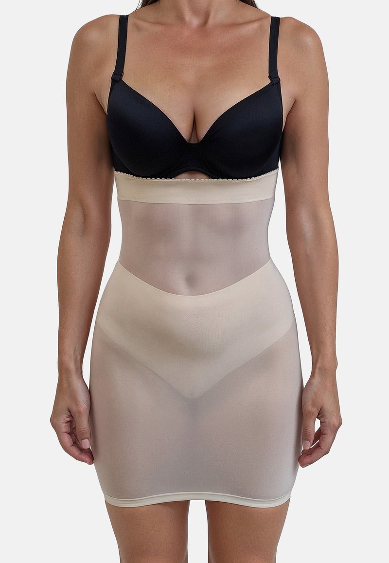 Slip beige modellante realizzato in materiale trasparente, con vita elastica e design senza cuciture, che arriva fino a metà coscia.