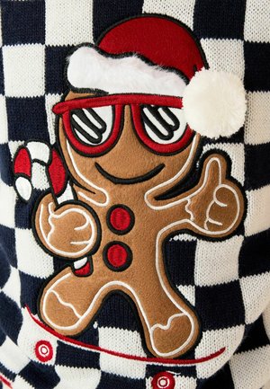 Stickad tröja med en pepparkaksgubbe i röda solglasögon, tomteluva och godispinne, på ett marinblått och vitt rutmönster.