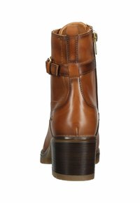 Brown leather ankle boot with a textured finish, zip closure, adjustable buckle strap, and a stacked heel.