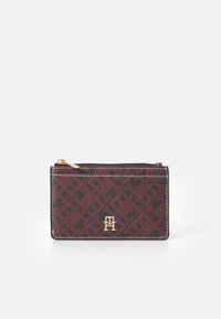 Red and black patterned cardholder made of textured material, with a gold logo and a zip closure along the top edge.