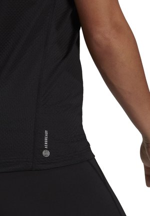 Maglietta atletica nera con tessuto strutturato, vestibilità slim e logo riflettente "AEROREADY" sull'orlo con cuciture flatlock.