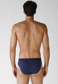 Slip da uomo color navy in tessuto liscio, con design a vita bassa e fascia elastica in vita, mostrati da dietro.
