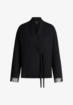 Cardigan noir style cache-cœur avec manches longues, bordure en dentelle aux poignets et fermeture à nouer à l’avant.