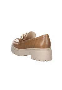 Brown leather slip-on shoes with a chunky cream sole, featuring a decorative twisted gold accent on the front and a smooth finish.