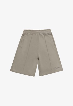 Beige sweatshorts med ribbestrikket liv, to sidelommer og dekorative sømmer. Brodert logo nederst til høyre.