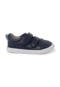 Navy blue leather sneaker with white rubber sole, featuring two Velcro straps and a textured finish. Rear loop for easy wearing.