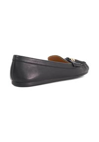 Black leather flat shoe with a smooth texture, rounded toe, and gold hardware accent. Low profile with a flexible sole design.