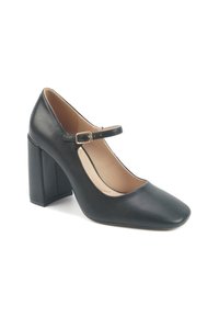 Black leather Mary Jane-style high heel shoe with a square toe, a gold buckle strap, and a block heel design. Smooth texture and minimalist style.