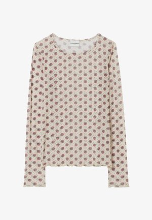 Top beige a maniche lunghe con piccolo motivo floreale rosso e verde, scollo rotondo e bordi smerlati.