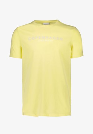 Camiseta de algodón amarilla con mangas cortas, cuello redondo y "COPENHAGUE" impreso en blanco en el pecho. Textura suave, diseño casual.
