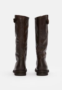 Brown leather knee-high boots with a slightly textured finish, flat soles, and a small buckle accent on the outer side.